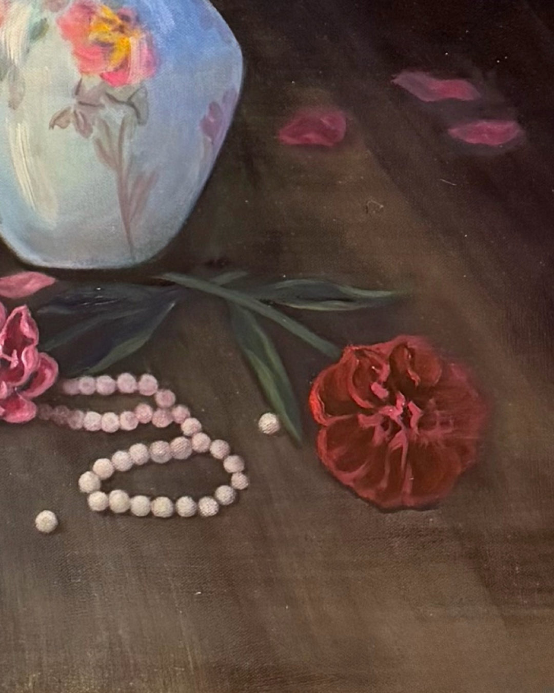 Red peony and pearls on the floor in front of the porcelain vase. 